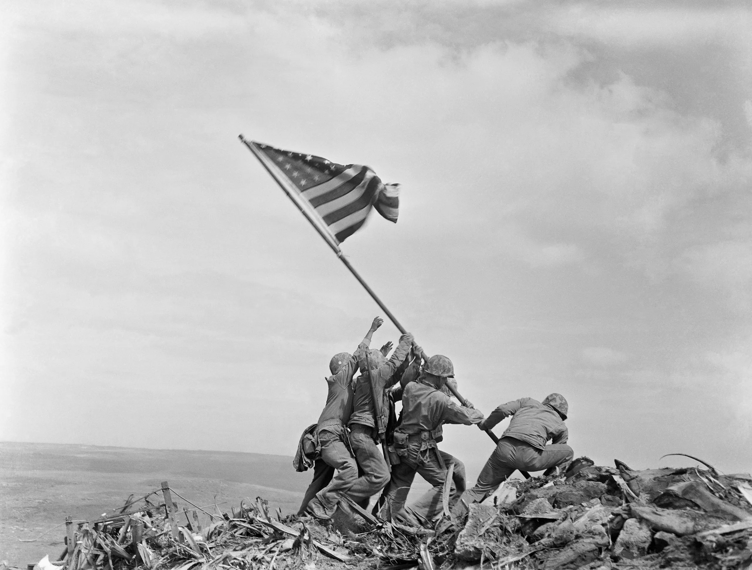A black and white photo of Raising the Flag on Iwo Jima
